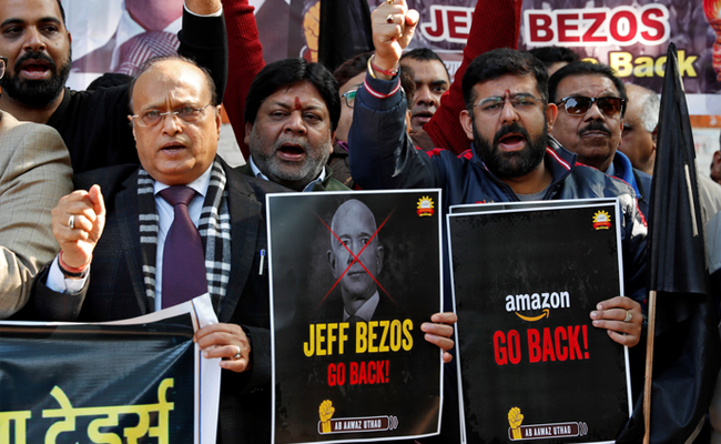 Indian traders protest against foreign e-tailers, burn effigies of Bezos